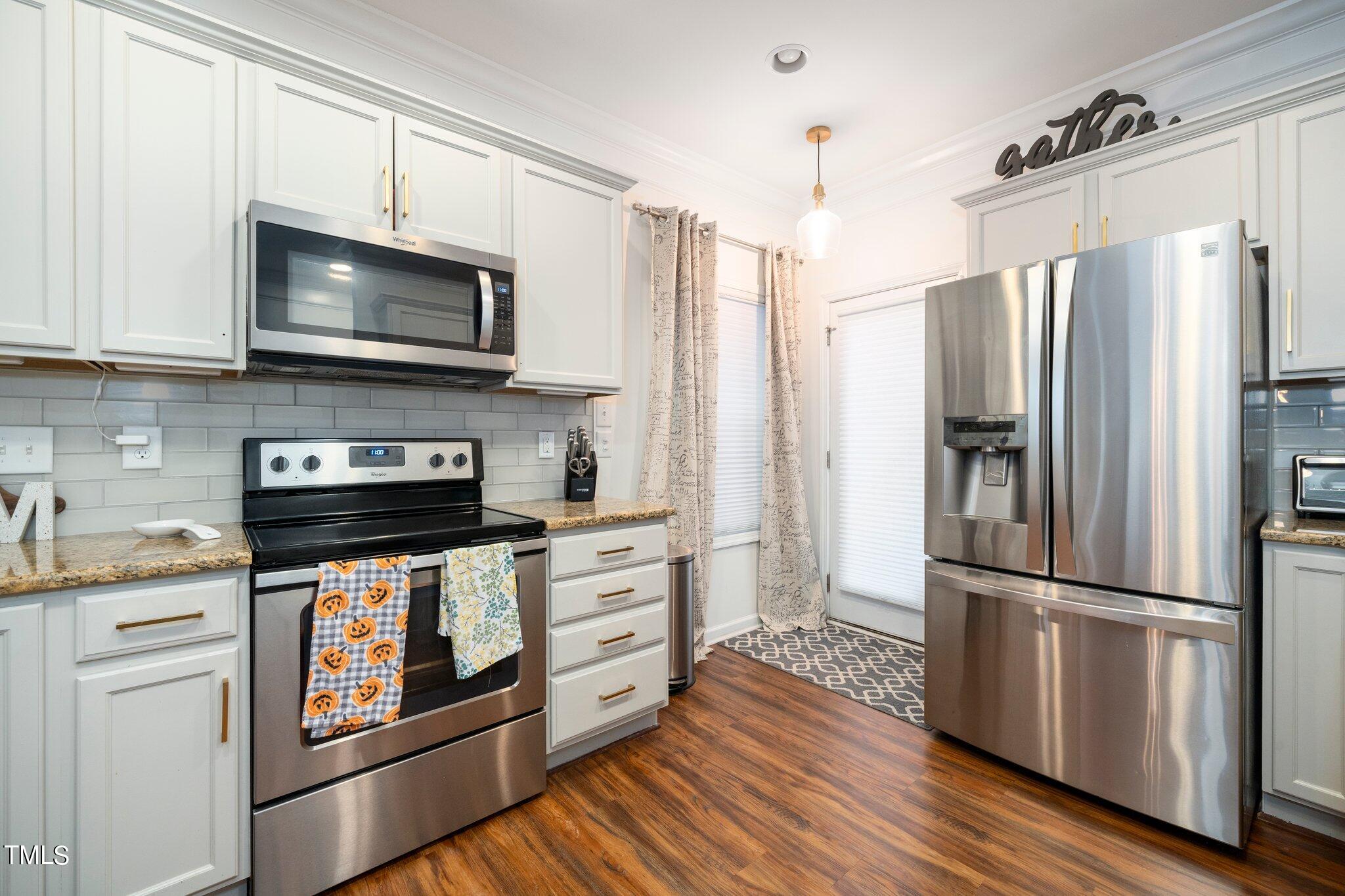 903 Ambergate Station Apex, NC 27502 - Photo 10 of 24 a kitchen with stainless steel appliances a refrigerator stove and microwave
