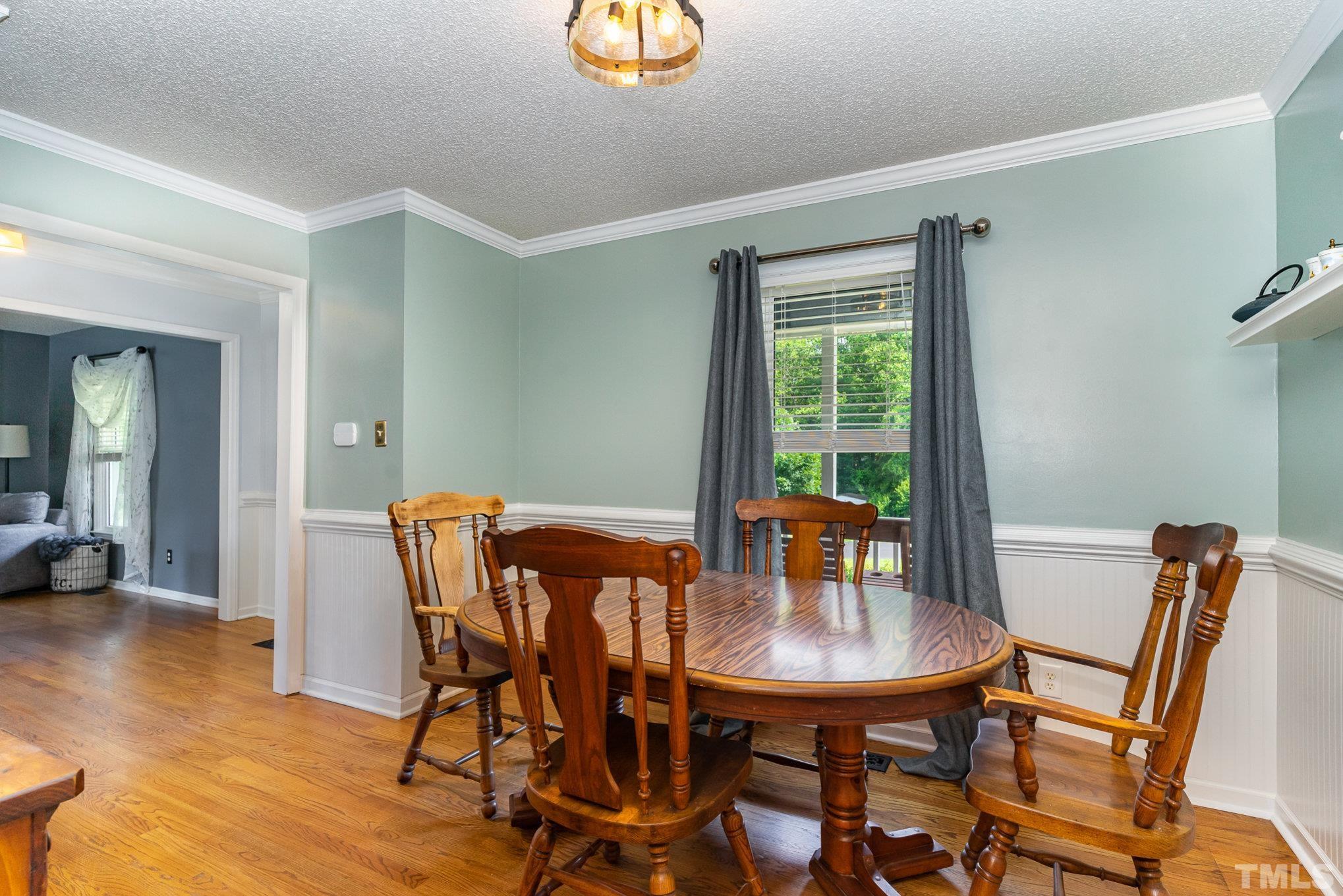 616 Jordan Ridge Lane Raleigh, NC 27603 - Photo 14 of 31 a view of a dining room with furniture and wooden floor
