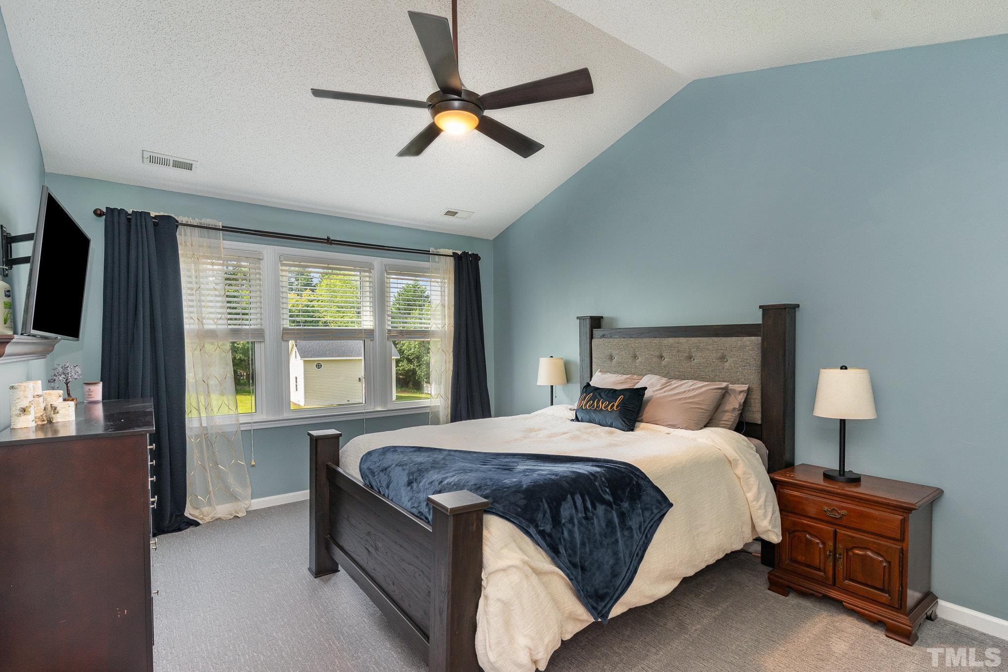 616 Jordan Ridge Lane Raleigh, NC 27603 - Photo 16 of 31 a bedroom with a bed dresser and a window