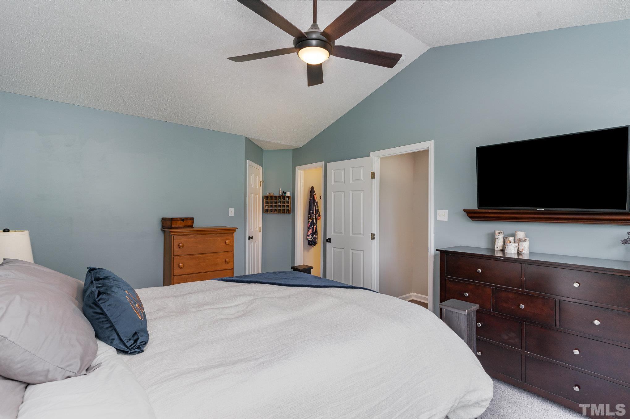 616 Jordan Ridge Lane Raleigh, NC 27603 - Photo 17 of 31 a bedroom with a bed and a flat screen tv