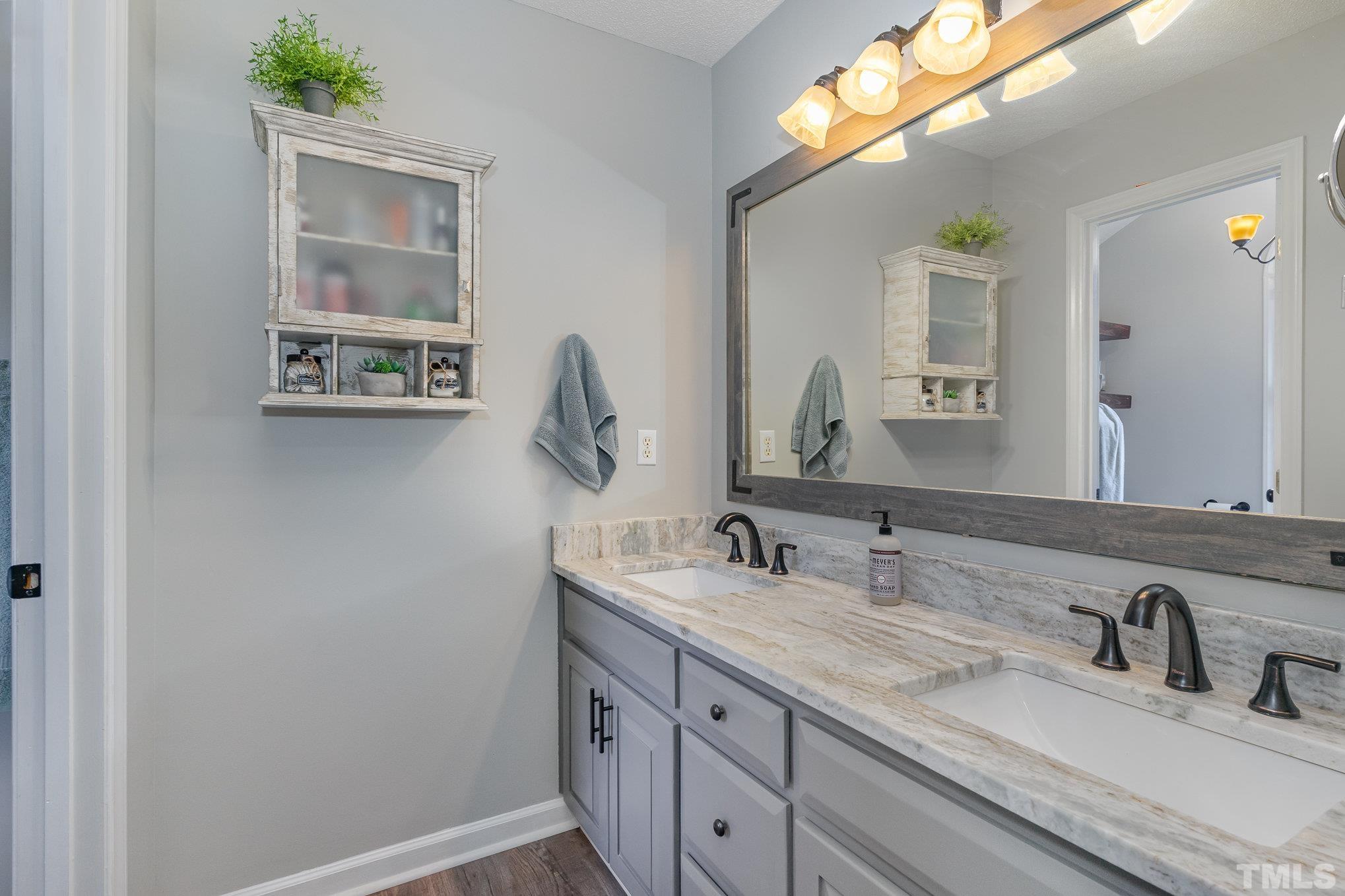 616 Jordan Ridge Lane Raleigh, NC 27603 - Photo 18 of 31 a bathroom with a double vanity sink and a mirror