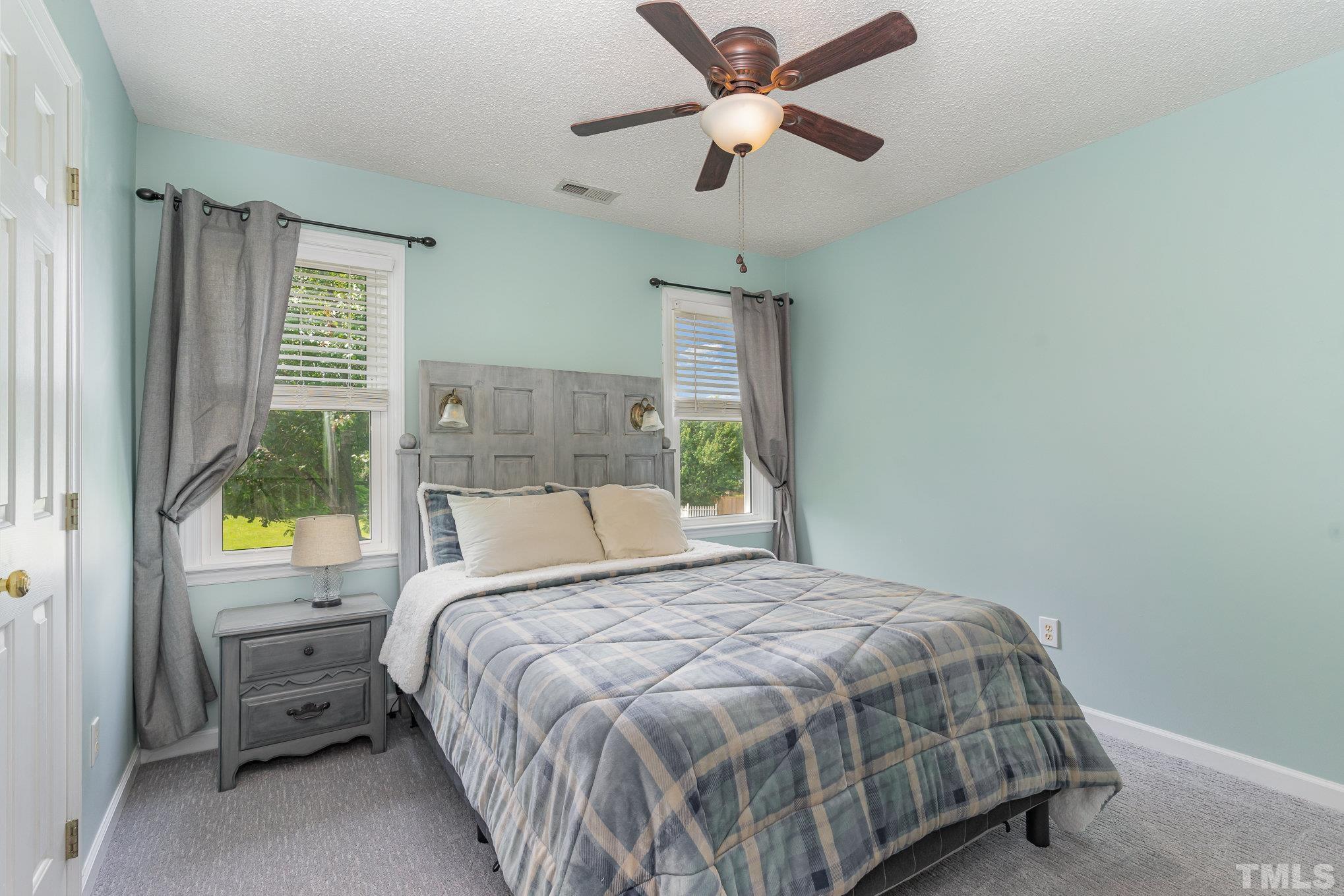 616 Jordan Ridge Lane Raleigh, NC 27603 - Photo 20 of 31 a bedroom with a bed and a window