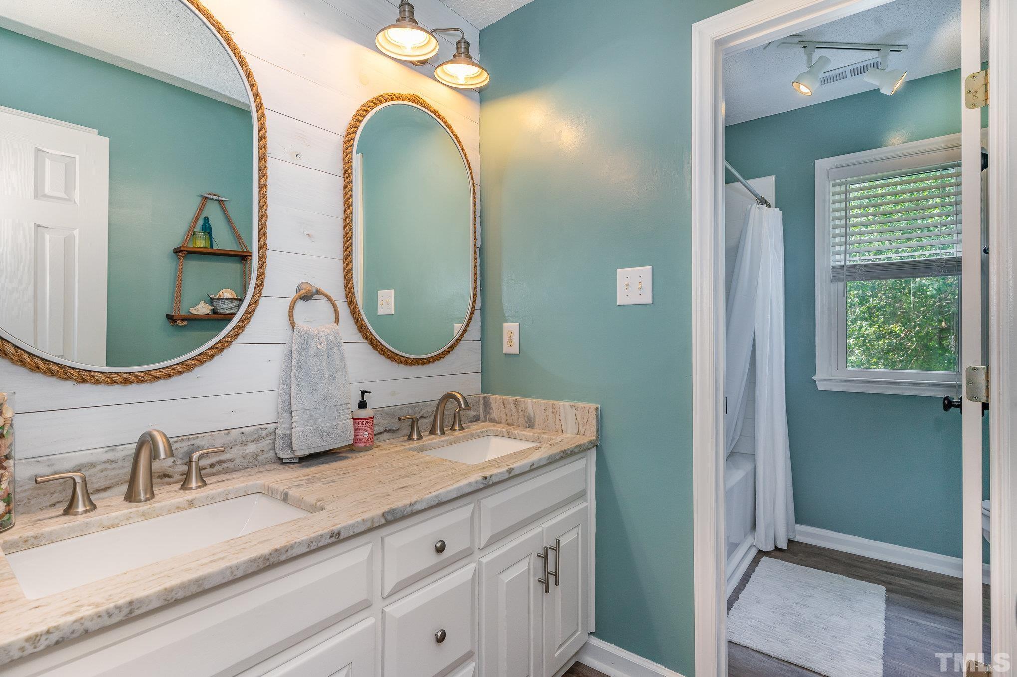 616 Jordan Ridge Lane Raleigh, NC 27603 - Photo 22 of 31 a bathroom with a granite countertop double vanity sinks and a mirror