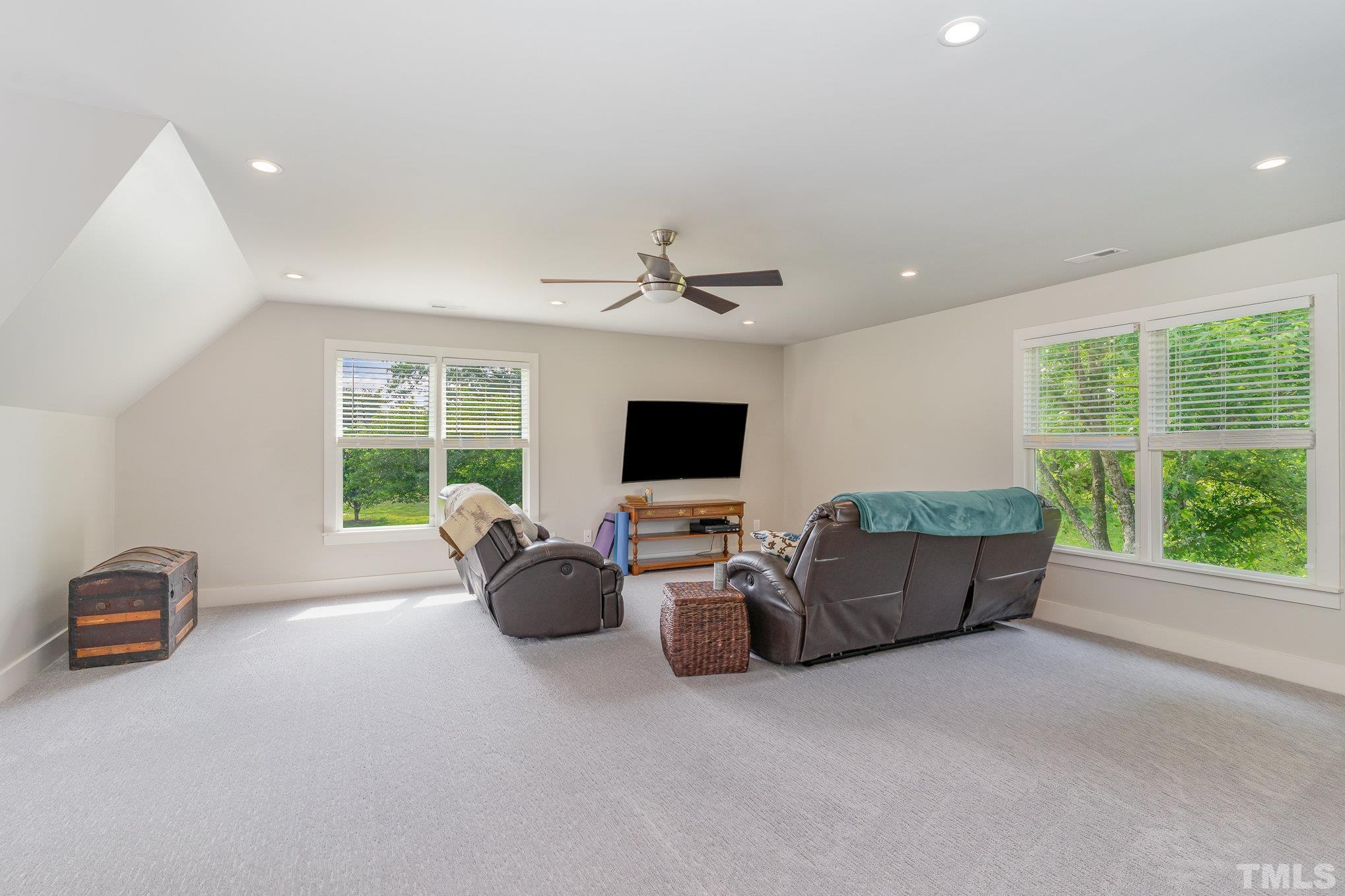 616 Jordan Ridge Lane Raleigh, NC 27603 - Photo 25 of 31 a living room with furniture and a flat screen tv