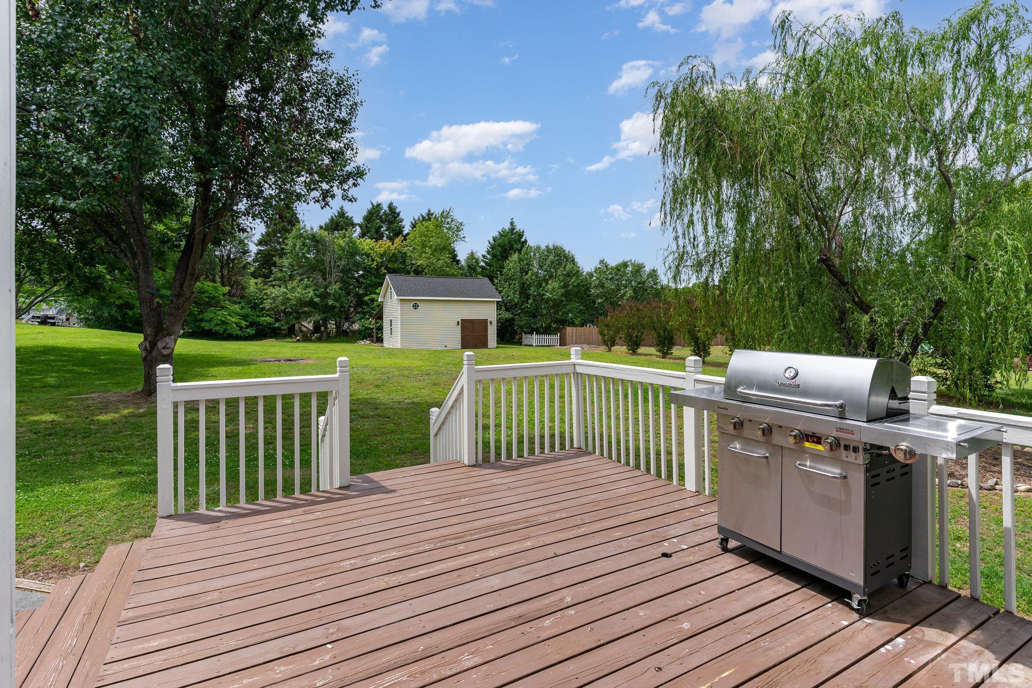 616 Jordan Ridge Lane Raleigh, NC 27603 - Photo 27 of 31 a view of a deck with wooden floor and fence with a large garden