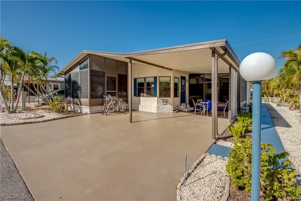 a view of a house with backyard and sitting area