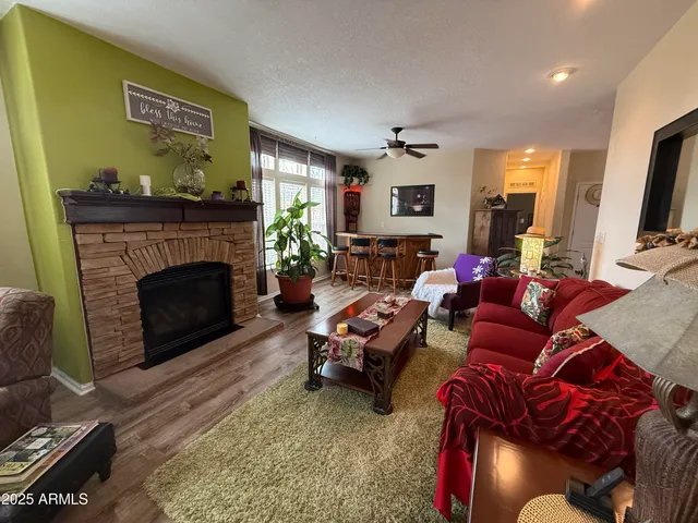 a living room with furniture fireplace and a large window