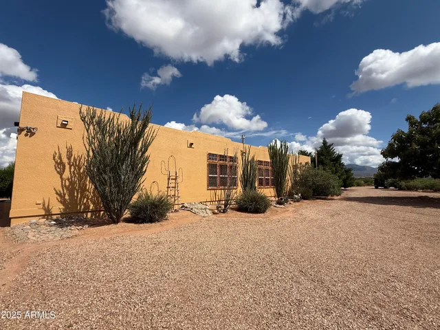 a backyard of a house with table and chairs