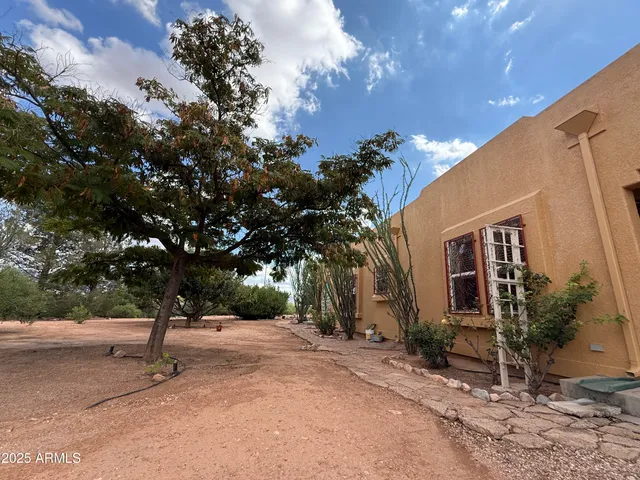 a view of a house with a tree in front
