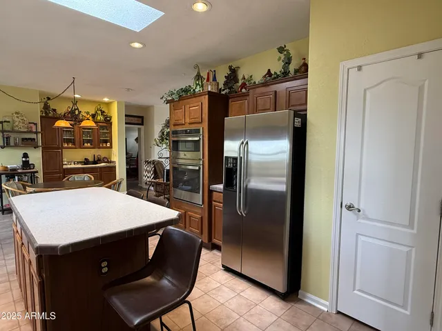 a kitchen with a refrigerator and table