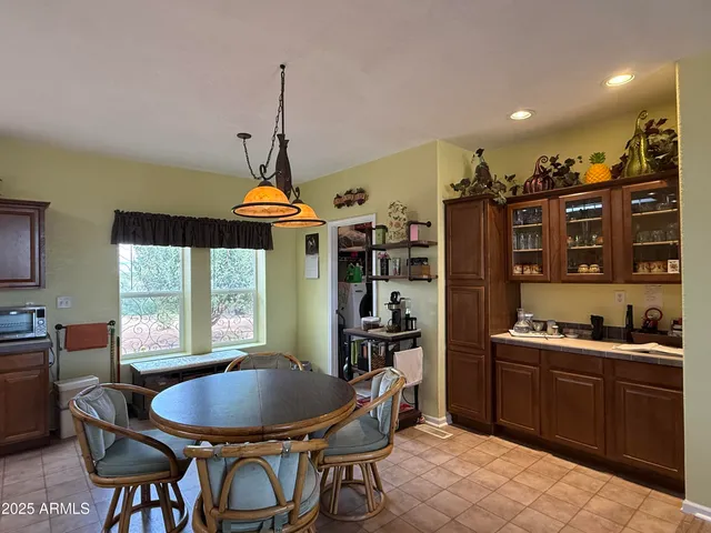 a dining room with furniture a window and kitchen view