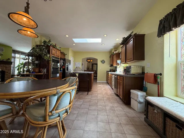 a kitchen with stainless steel appliances granite countertop a sink a stove and a refrigerator