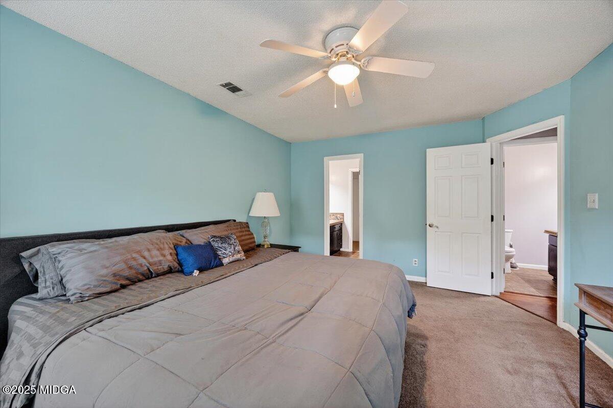 117 Chadwick Drive Macon, GA 31210 - Photo 11 of 32 a bedroom with a bed and a chandelier