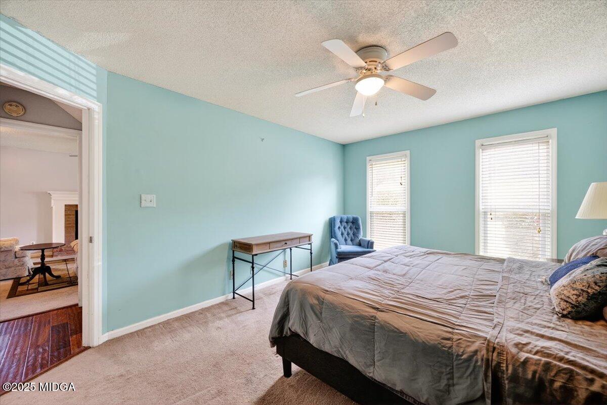 117 Chadwick Drive Macon, GA 31210 - Photo 13 of 32 a bedroom with a large bed and a chandelier