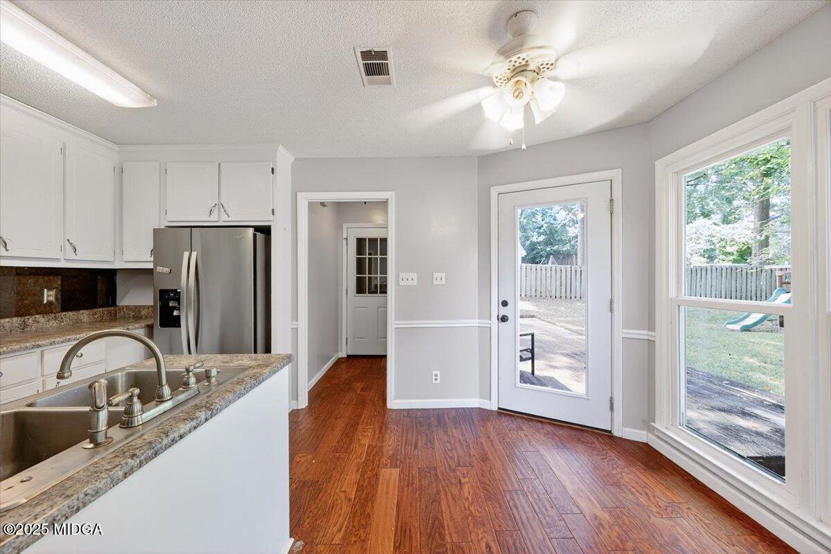 117 Chadwick Drive Macon, GA 31210 - Photo 17 of 32 a kitchen with stainless steel appliances granite countertop a refrigerator a sink a stove and island with wooden floor