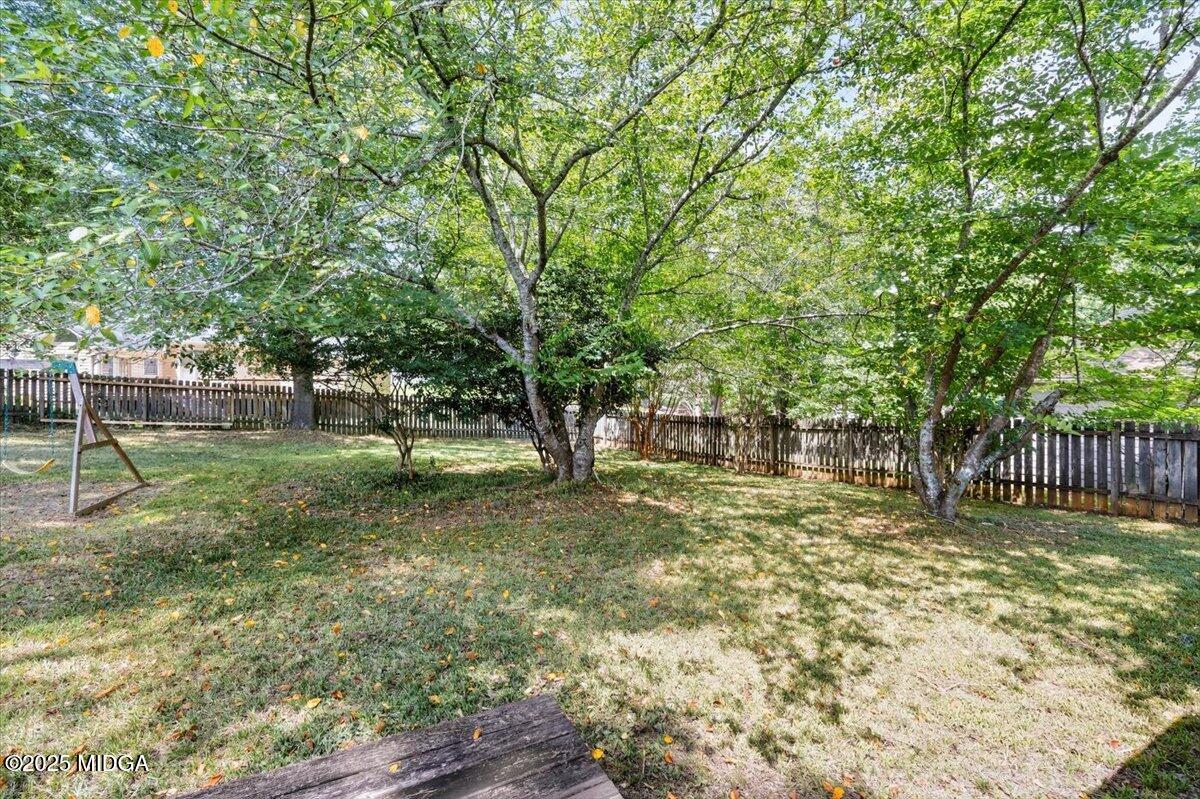 117 Chadwick Drive Macon, GA 31210 - Photo 23 of 32 a backyard of a house with lots of plants and tree