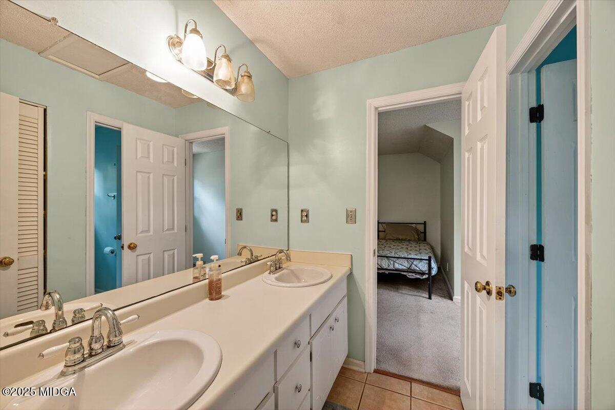 117 Chadwick Drive Macon, GA 31210 - Photo 30 of 32 a en suite bathroom with a double vanity sink and a mirror