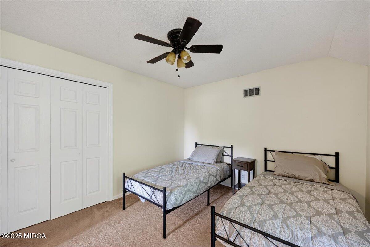 117 Chadwick Drive Macon, GA 31210 - Photo 31 of 32 a bedroom with a bed and ceiling fan