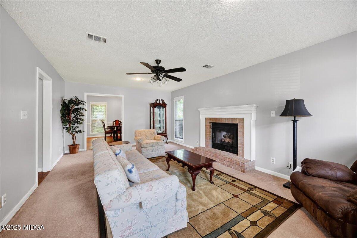 117 Chadwick Drive Macon, GA 31210 - Photo 5 of 32 a living room with furniture and a fireplace