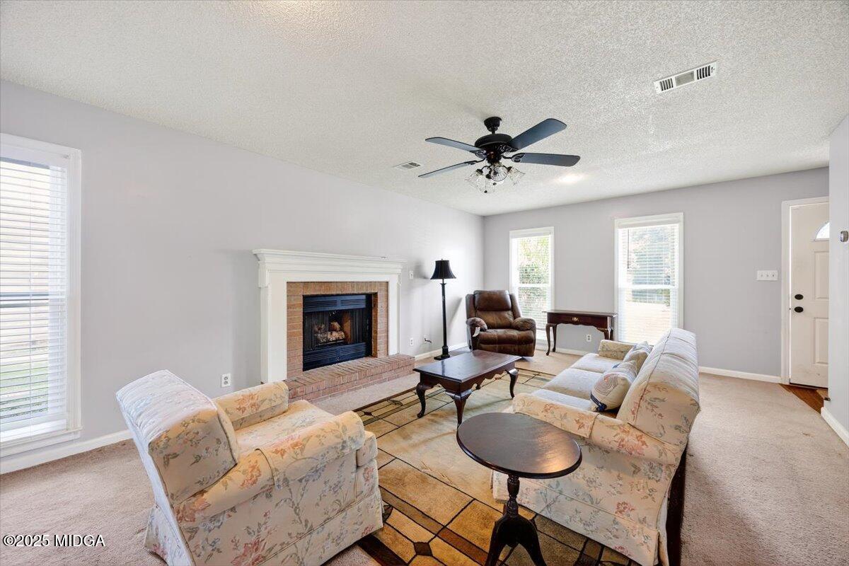 117 Chadwick Drive Macon, GA 31210 - Photo 6 of 32 a living room with furniture a fireplace and a window