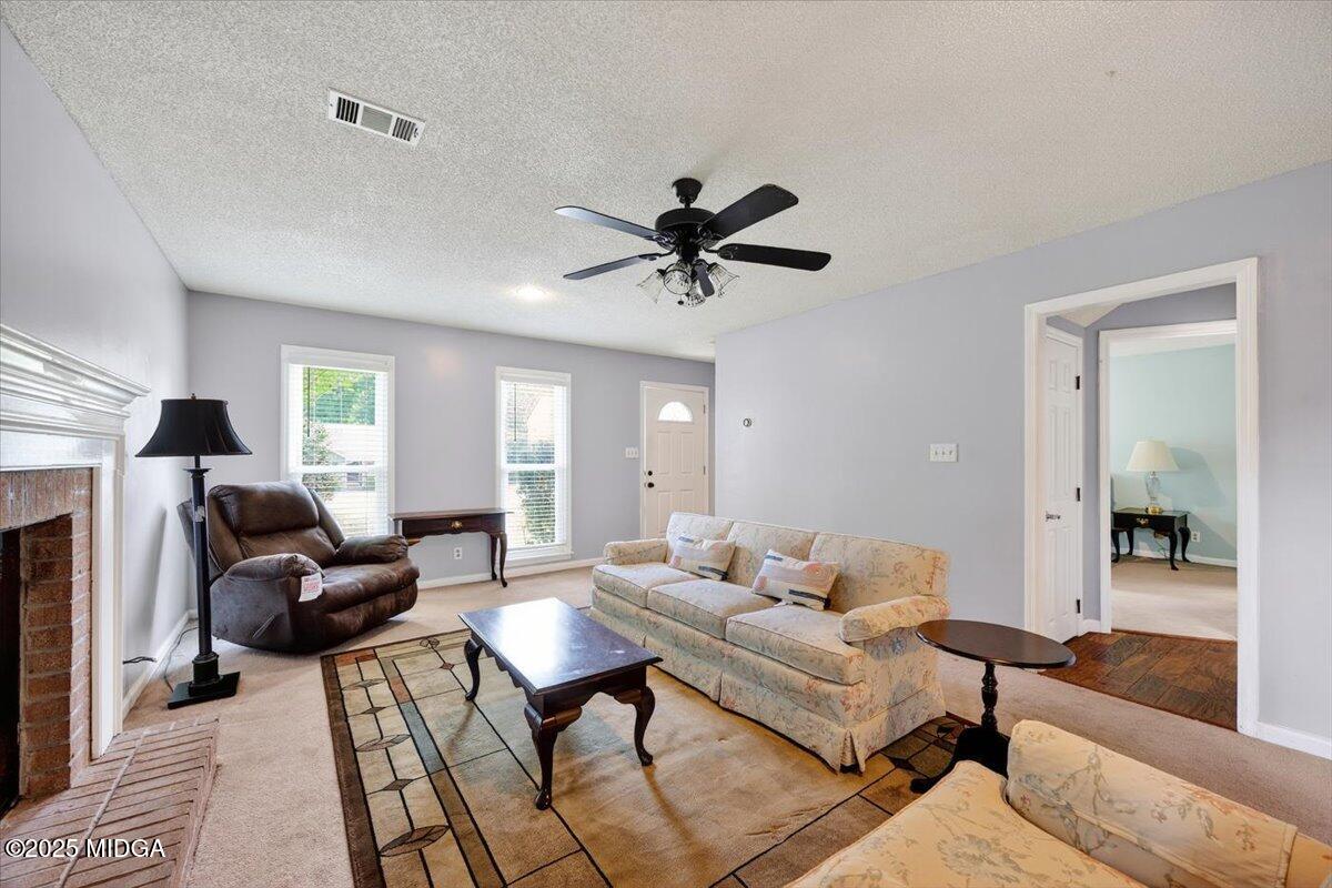 117 Chadwick Drive Macon, GA 31210 - Photo 7 of 32 a living room with furniture and a fireplace