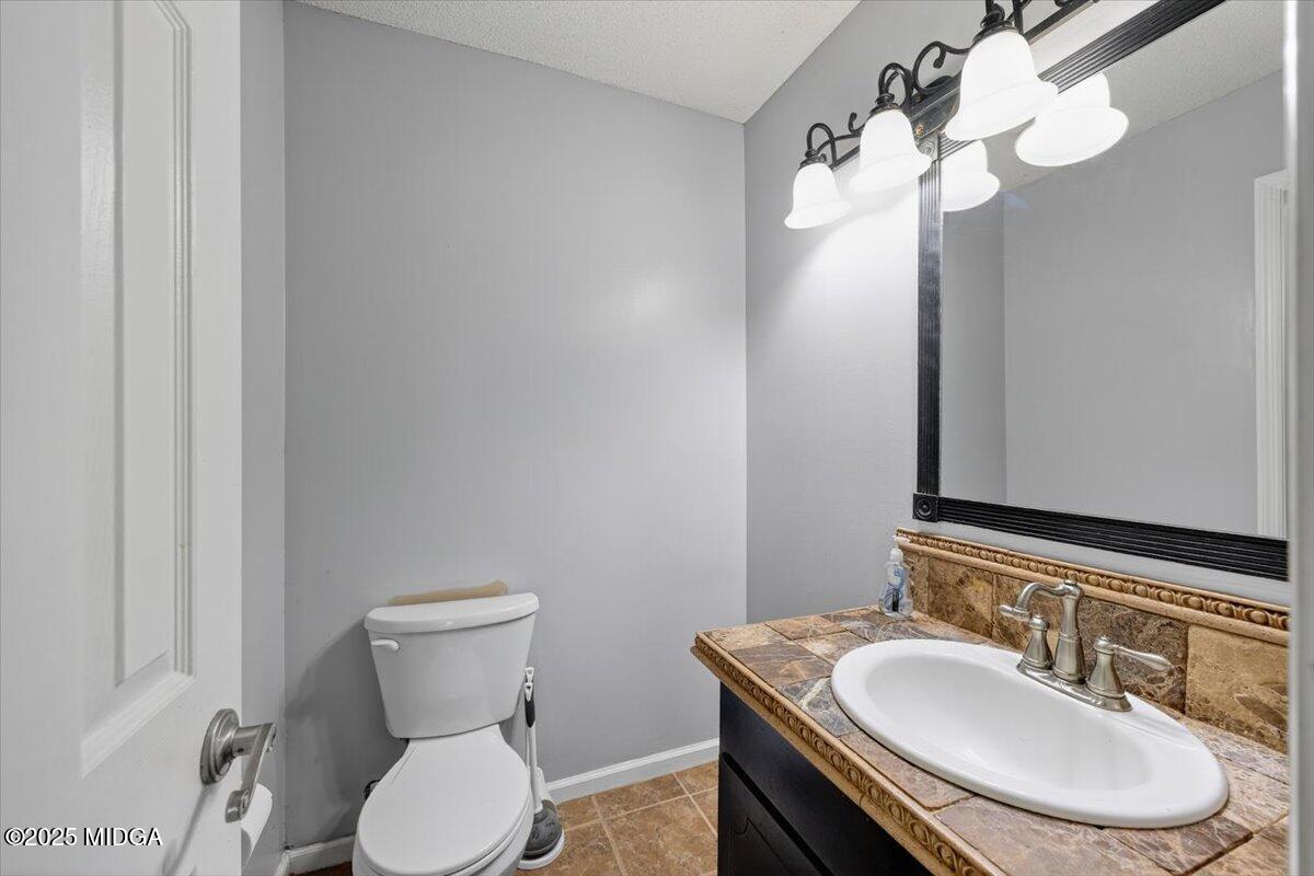 117 Chadwick Drive Macon, GA 31210 - Photo 9 of 32 a bathroom with a toilet sink and mirror