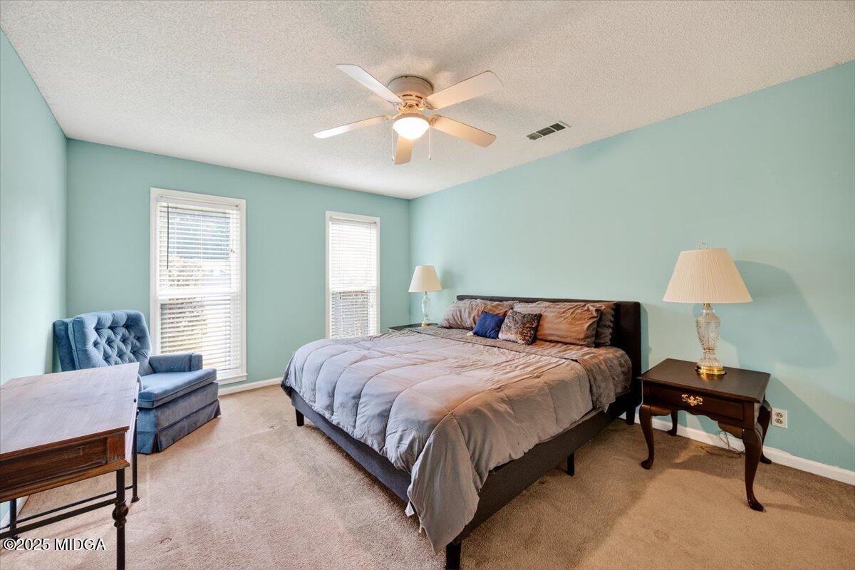 117 Chadwick Drive Macon, GA 31210 - Photo 10 of 32 a bedroom with a bed and a chandelier