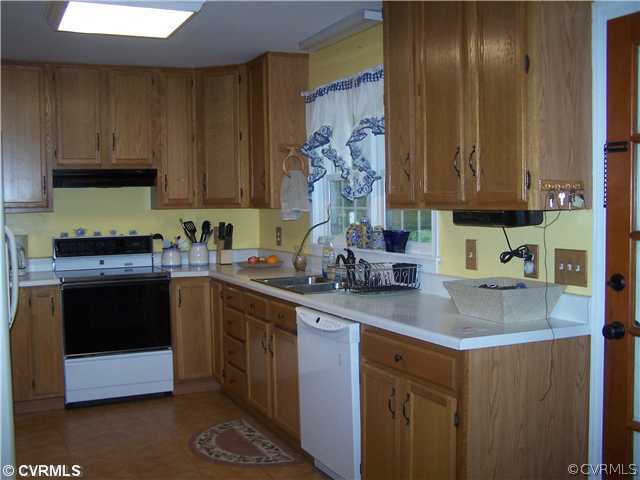 13900 Harrowgate Road Chester, VA 23831 - Photo 4 of 7 a kitchen with stainless steel appliances granite countertop a sink stove and cabinets
