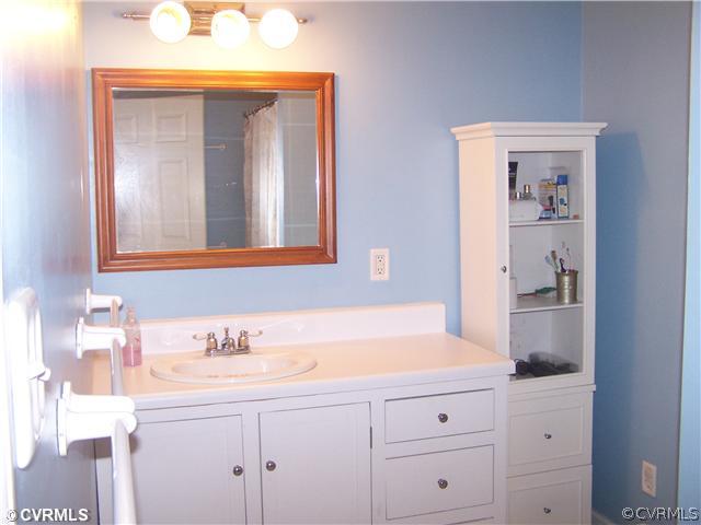 13900 Harrowgate Road Chester, VA 23831 - Photo 7 of 7 a bathroom with a sink and a mirror