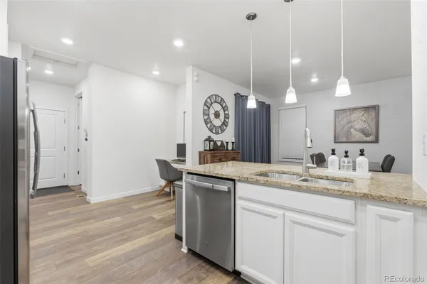 a bathroom with a granite countertop sink a mirror and a shower