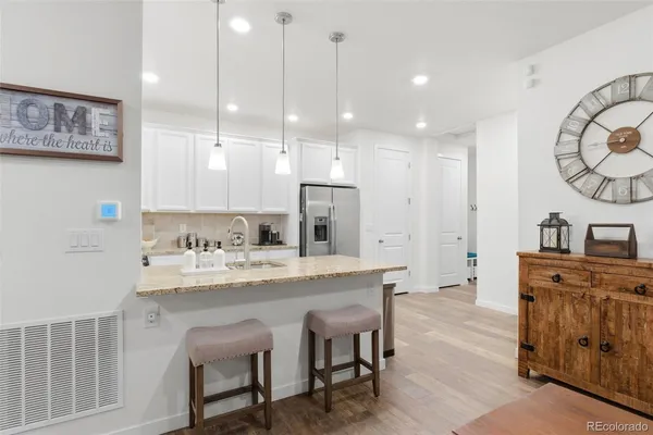 a kitchen with stainless steel appliances granite countertop a kitchen island a stove and a sink