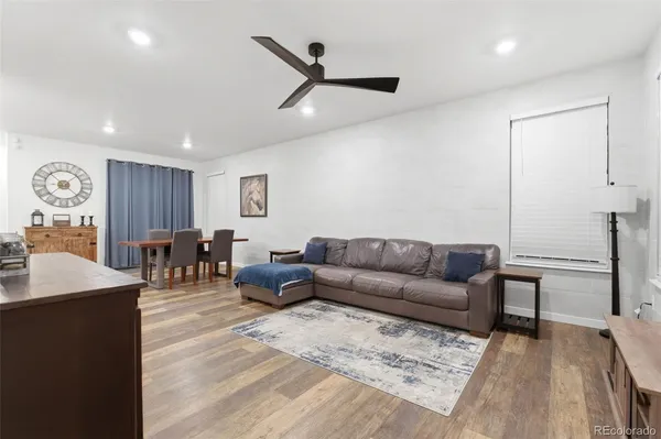 a living room with furniture and view of kitchen