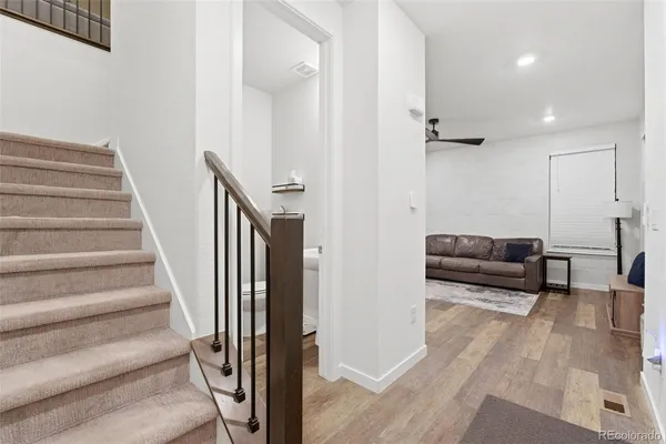 a living room with furniture and a stair