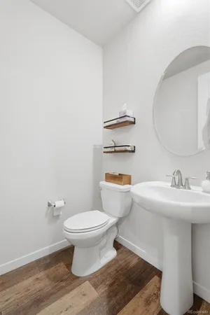 a bathroom with a sink toilet and a mirror