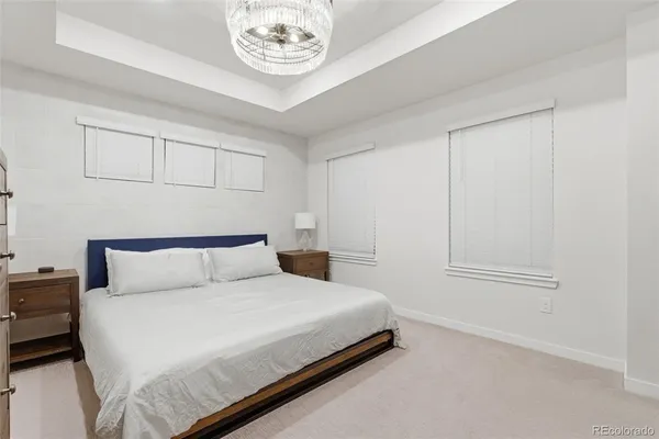 a bedroom with a bed and a chandelier