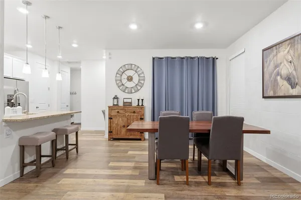 a view of a dining room with furniture and wooden floor