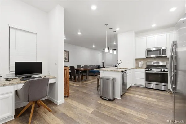a kitchen with a sink appliances and cabinets
