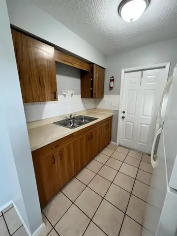 a kitchen with stainless steel appliances a refrigerator and a stove top oven