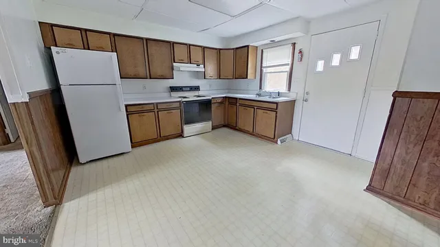 a kitchen with stainless steel appliances a refrigerator sink and cabinets