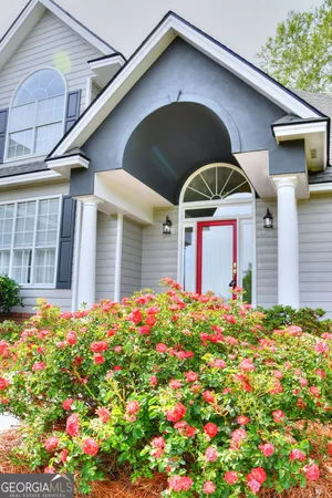 a flower garden in front of a house