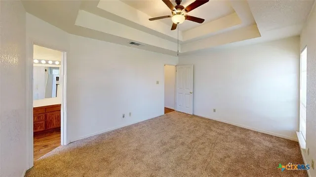 a view of a hallway with a room and wooden floor