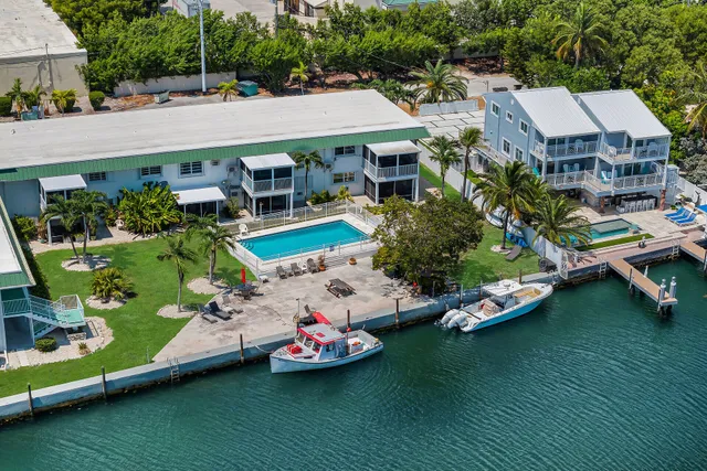 an aerial view of a house with swimming pool and outdoor seating