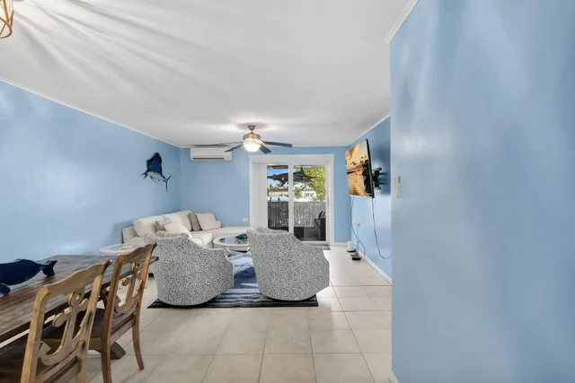 a view of an empty room with kitchen and a window