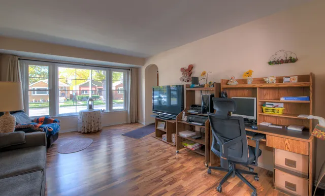 a living room with furniture and wooden floor