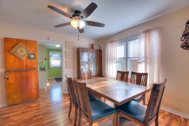 a bedroom with a bed dresser and a large window