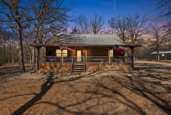 a view of a chairs and table in the backyard