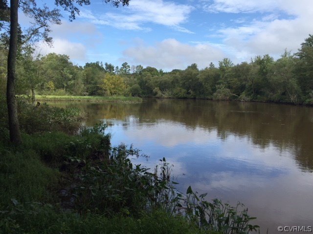 367 Harris Road Aylett, VA 23009 - Photo 1 of 6 a view of a lake with a yard and mountain view