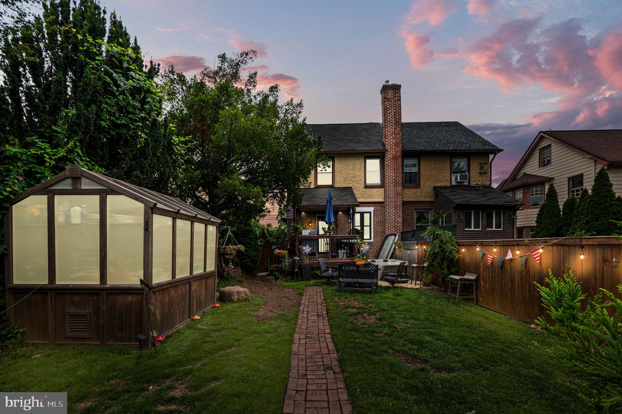 3 Township Line Road Elkins Park, PA 19027 - Photo 2 of 40 Charming backyard oasis at dusk.