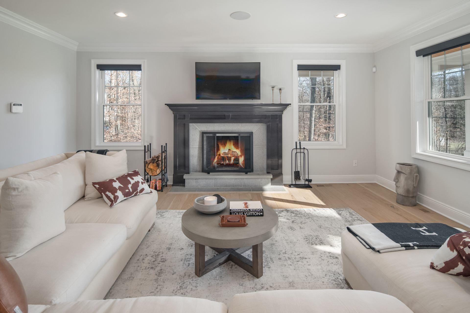 716 Cheese Spring Road New Canaan, CT 06840 - Photo 11 of 56 a living room with furniture and a fireplace