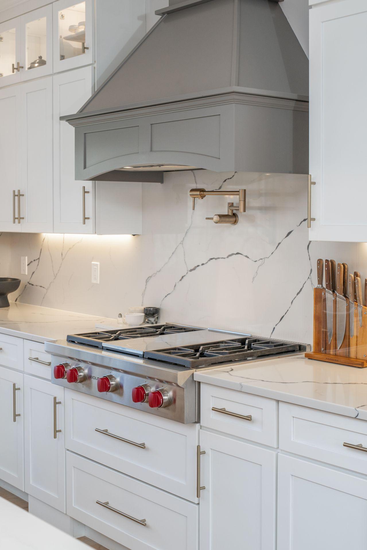 716 Cheese Spring Road New Canaan, CT 06840 - Photo 14 of 56 a kitchen with white cabinets and white appliances